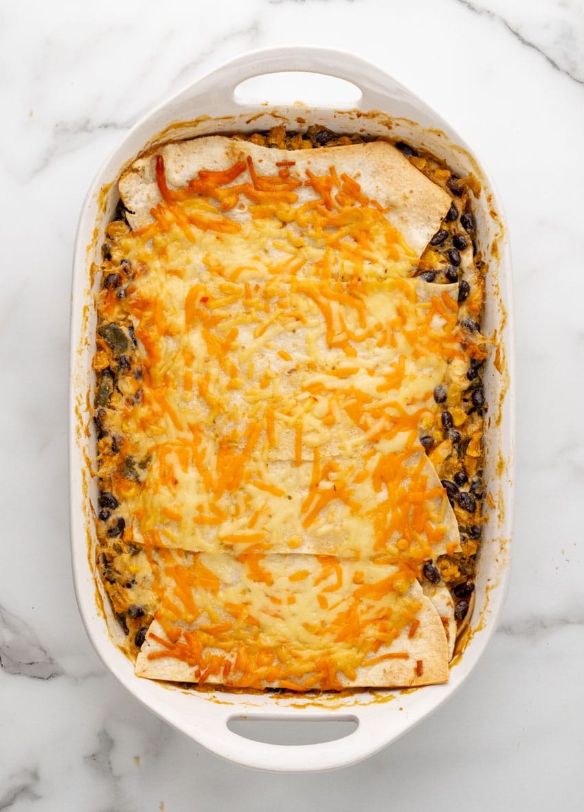 a baked cheesy tex mex lasagna in a white casserole dish