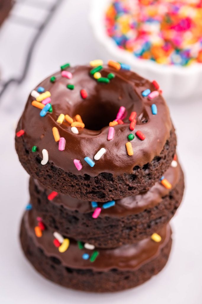 three double chocolate donuts stacked on top of each other