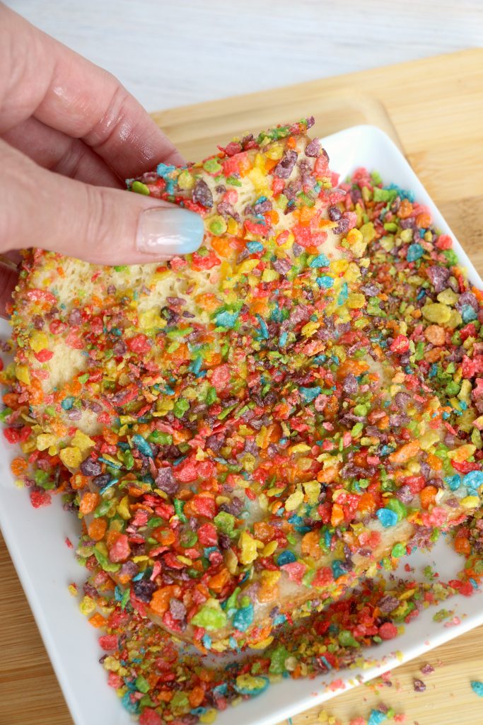 fruity pebble crusted slices of bread on a white plate