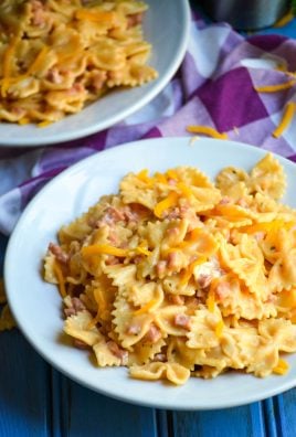 two white bowls filled with cheesy Instant Pot crack pasta with ham