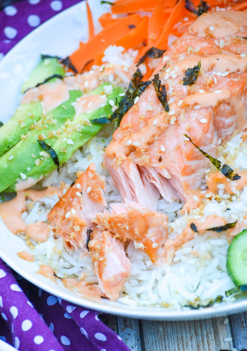 flaked salmon on top of a salmon sushi bowl