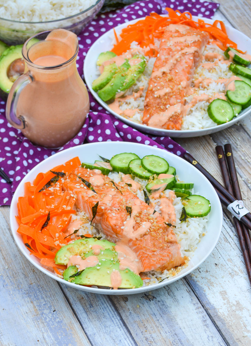 two sushi rice bowls with salmon