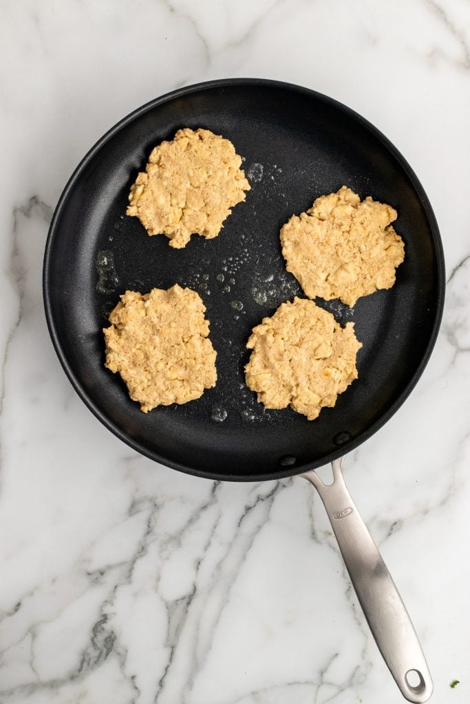 saltine cracker fritters cooking in a black skillet