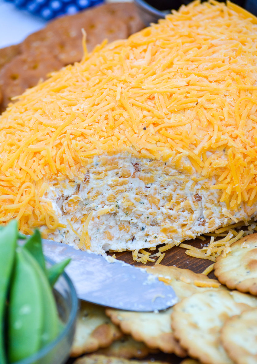 a cheddar bacon ranch cheeseball opened to reveal the inside