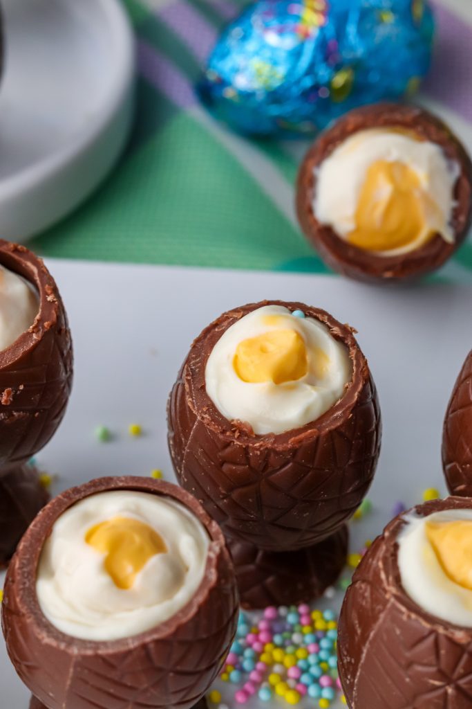 cheesecake stuffed chocolate Easter eggs on a white platter