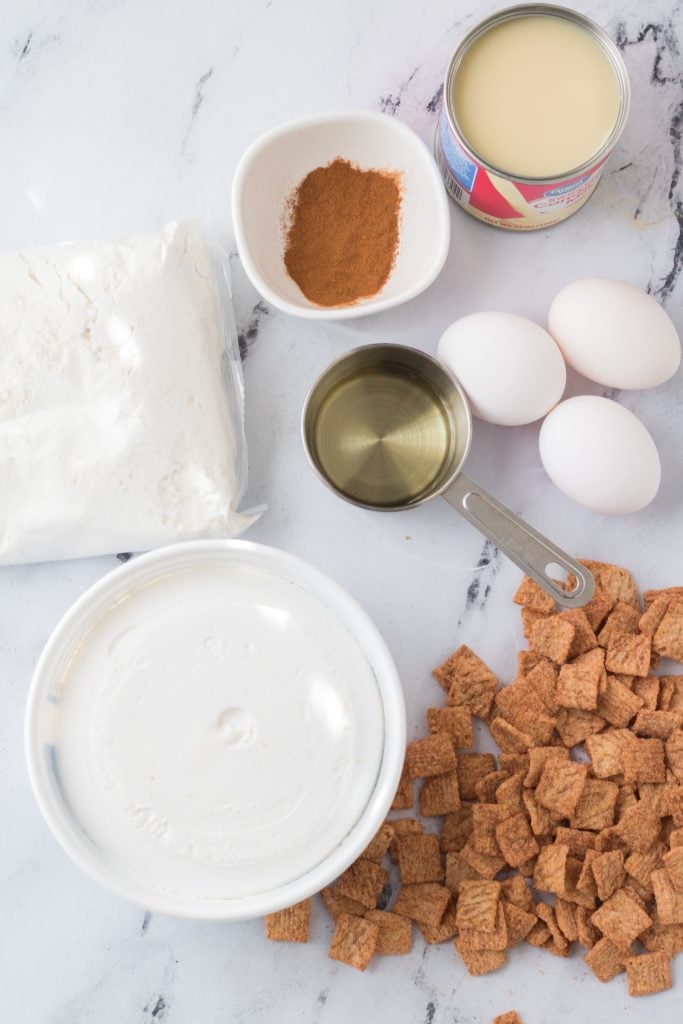 an overhead image showing the measured ingredients needed to make a cinnamon toast crunch poke cake