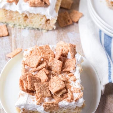 a slice of cinnamon toast crunch poke cake on a small white plate
