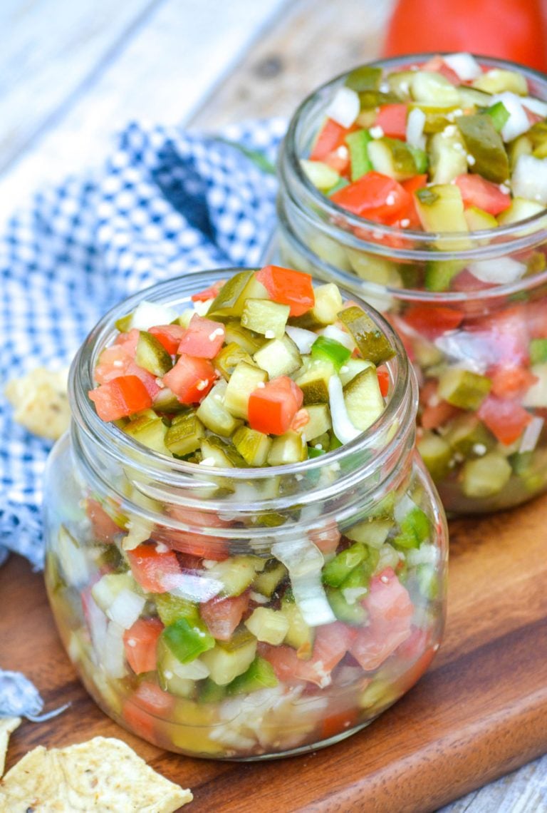 fresh pickle de gallo in two small glass mason jars on a wooden cutting board