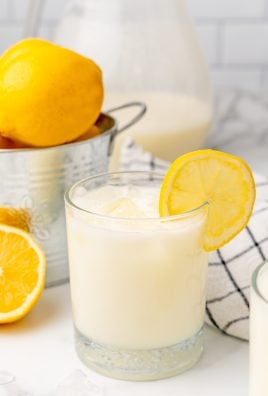 creamy lemonade in glasses garnished with sliced lemon