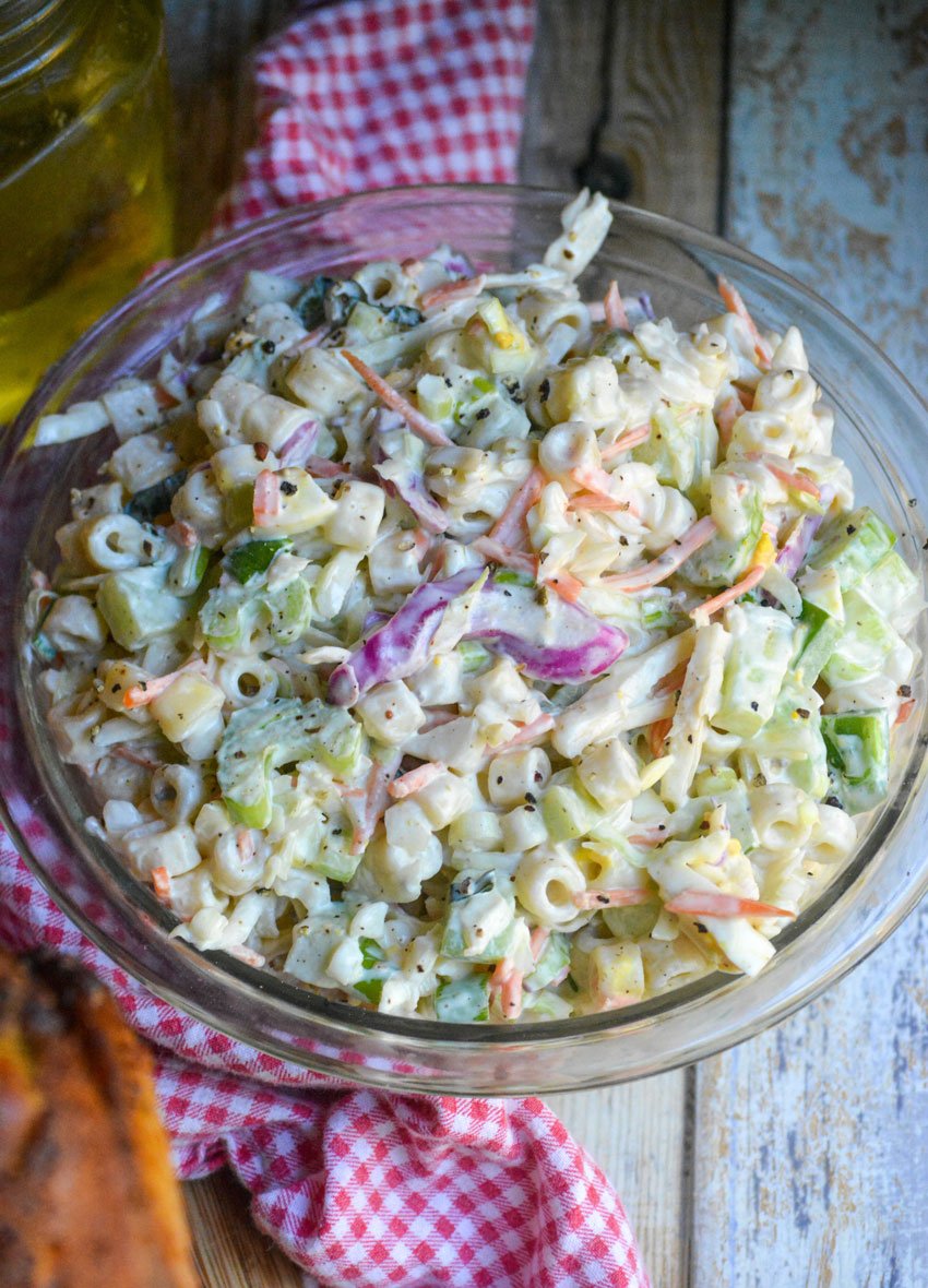 creamy coleslaw pasta salad in a glass mixing bowl