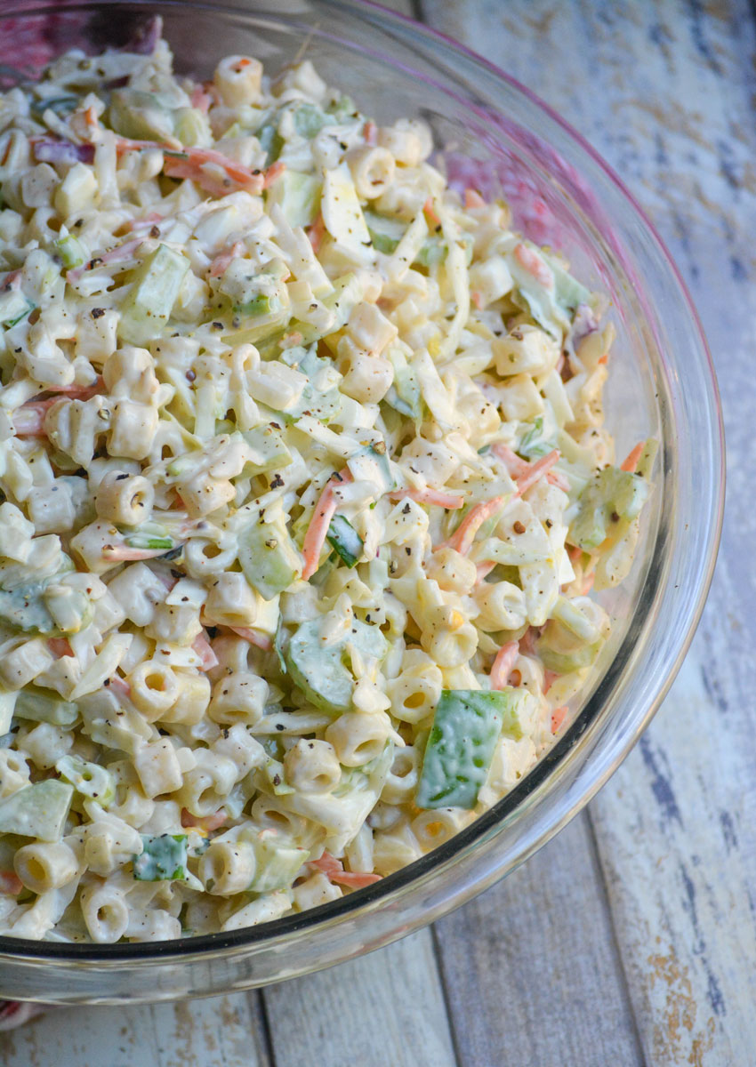 macaroni salad with coleslaw in a glass mixing bowl