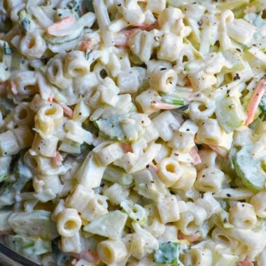 creamy coleslaw pasta in a glass mixing bowl