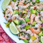 easy copycat costco shrimp ceviche in a white bowl with fresh lime wedges