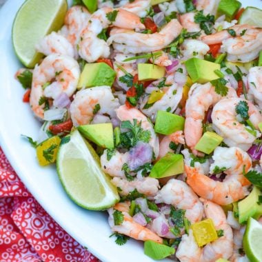 easy copycat costco shrimp ceviche in a white bowl with fresh lime wedges