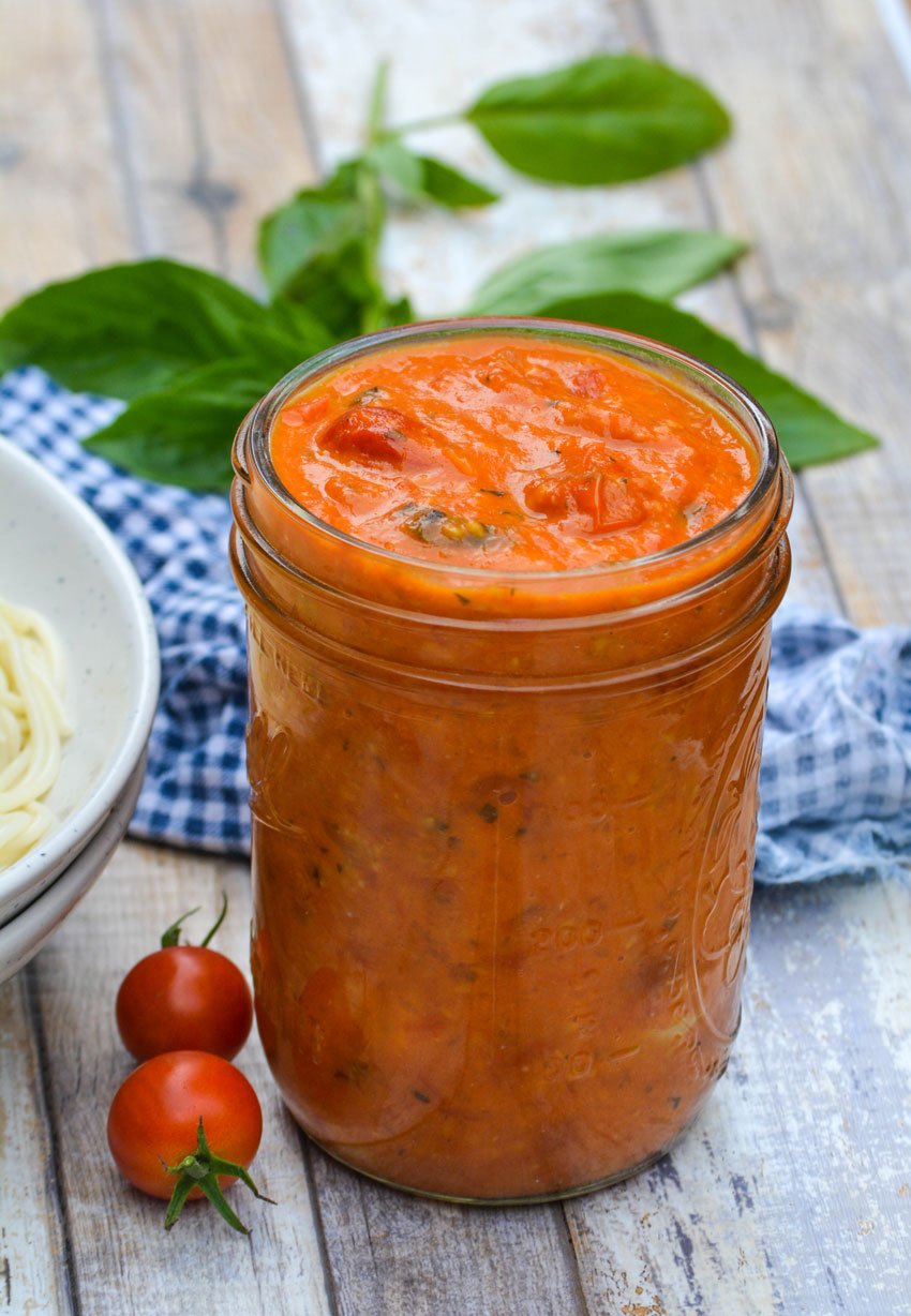 a glass mason jar filled with sweet cherry tomato sauce