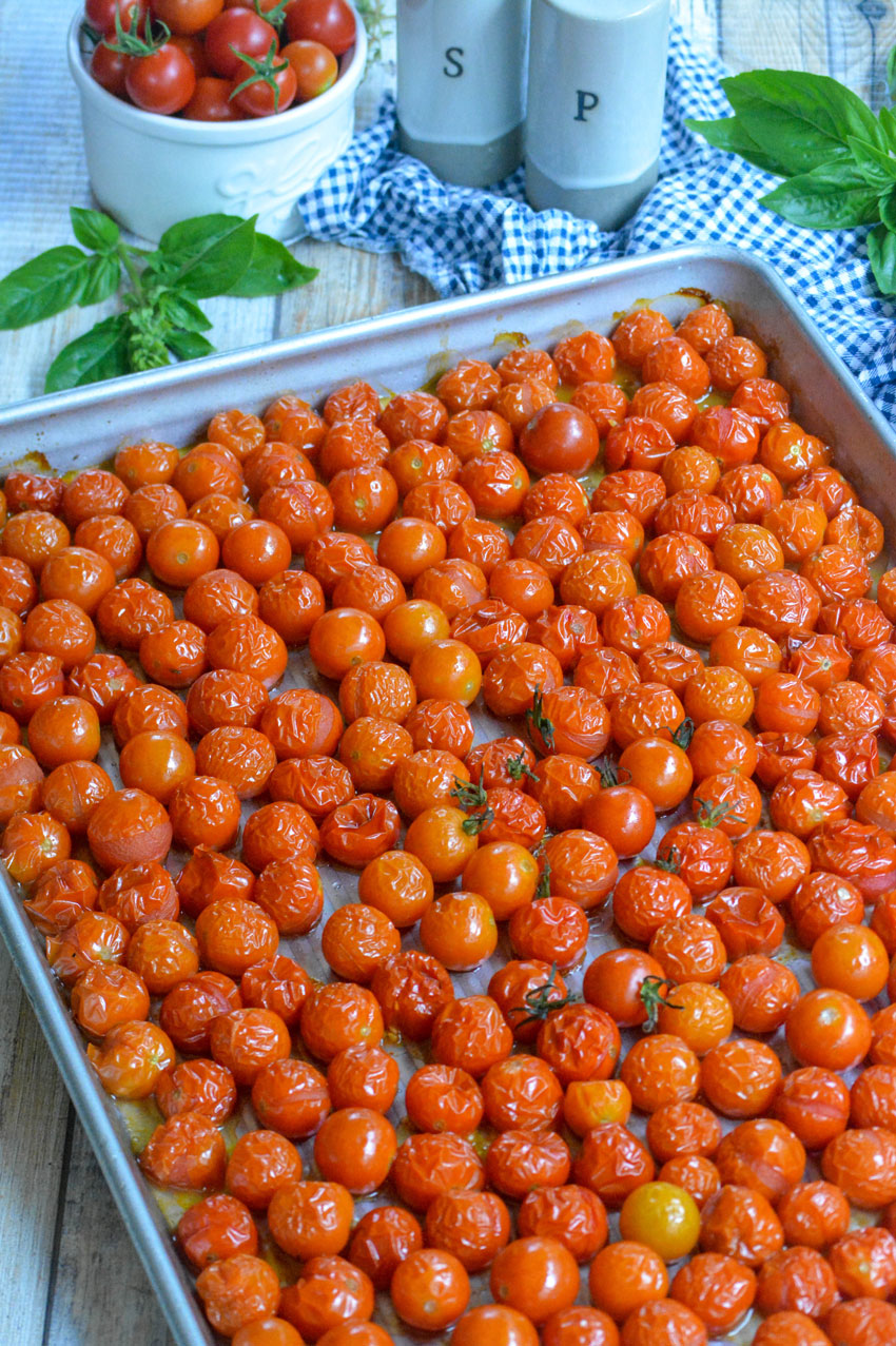 blistered cherry tomatoes on a metal sheet pan