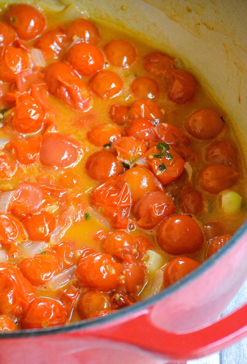 cherry tomatoes with olive oil in a red pot