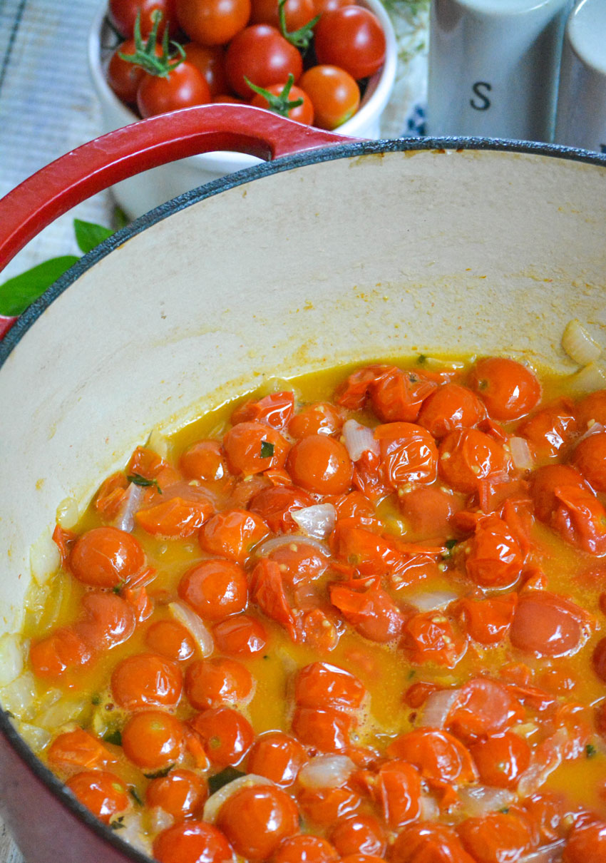 cherry tomatoes with olive oil in a red pot