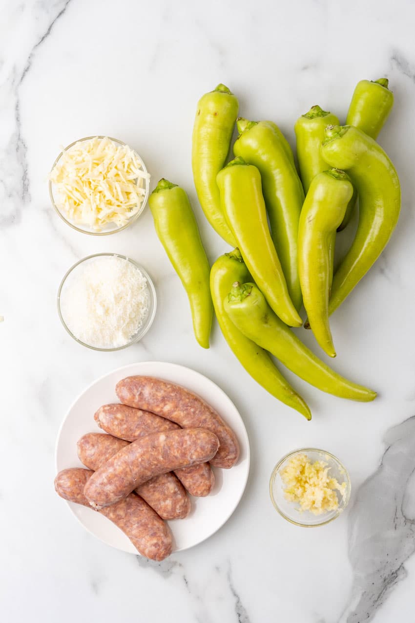 an overhead image showing the measured ingredients needed to make sausage stuffed banana peppers