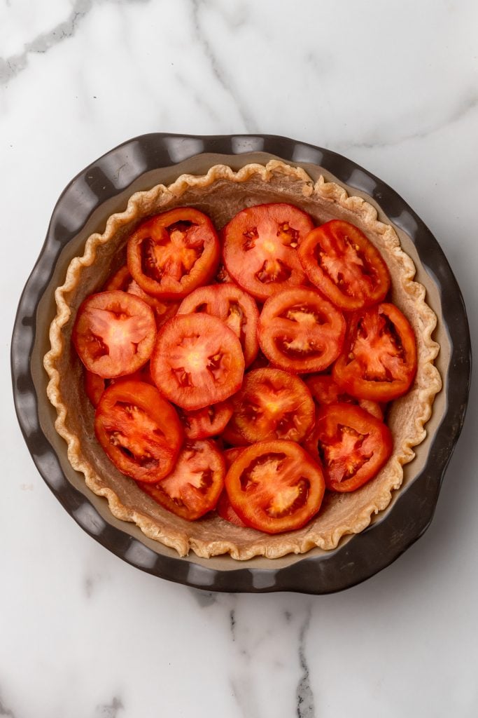slices of tomato layered inside a pie crust