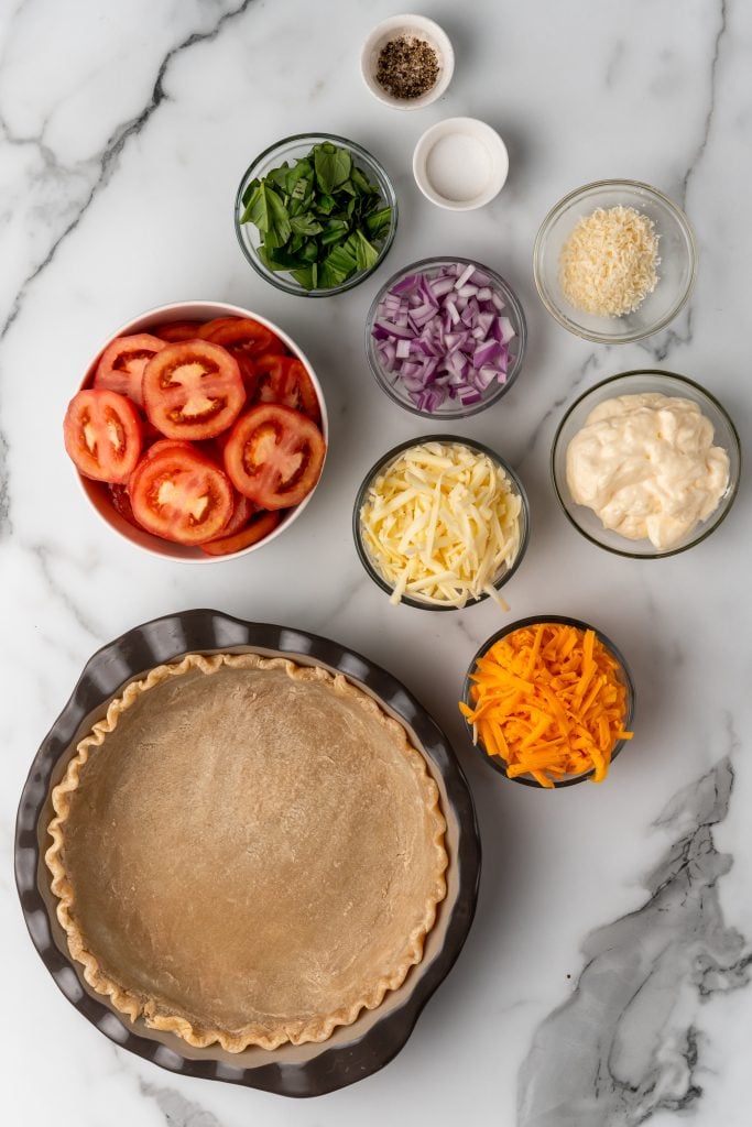 an overhead image showing the measured ingredients needed to make a classic tomato pie