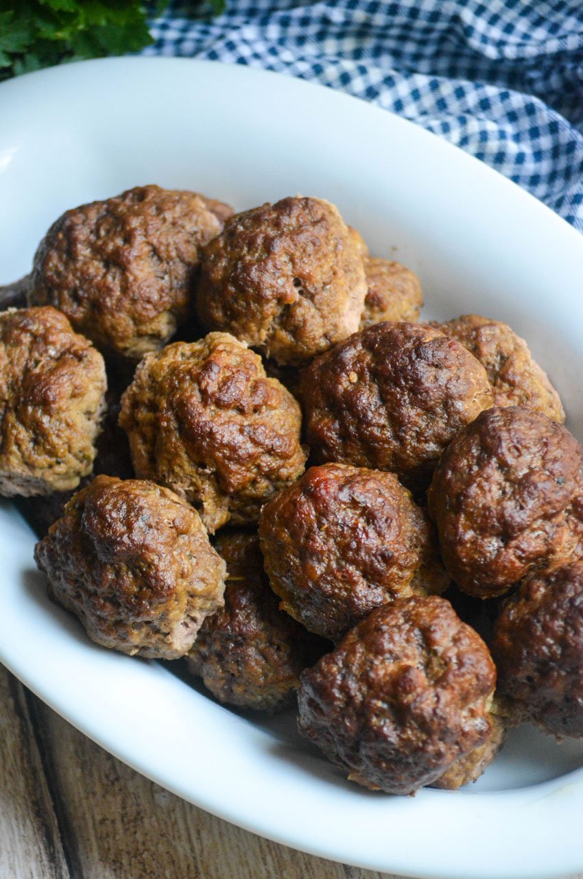 smoked meatballs piled in a shallow white serving platter