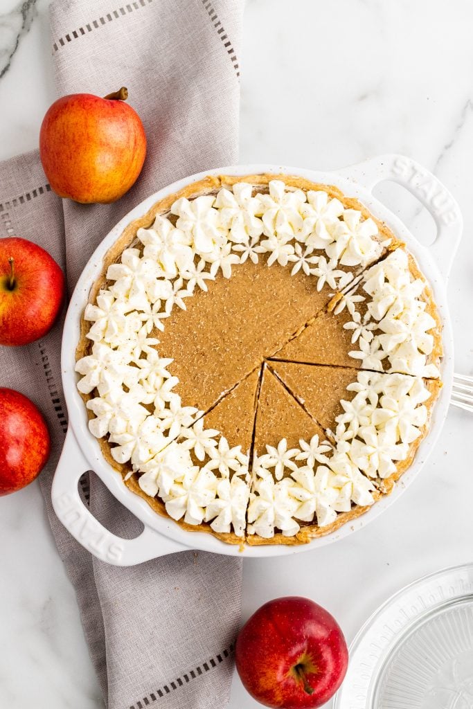 a sliced apple butter pie in a white pie plate with handles