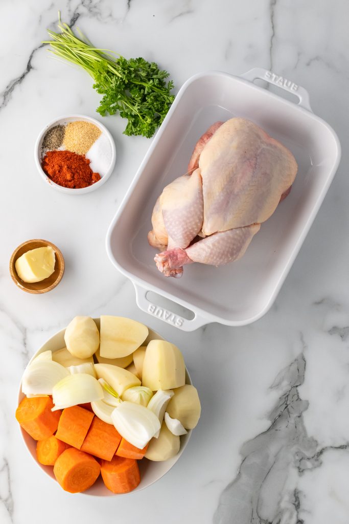 overhead image showing the measured ingredients needed to make a whole chicken in the crockpot