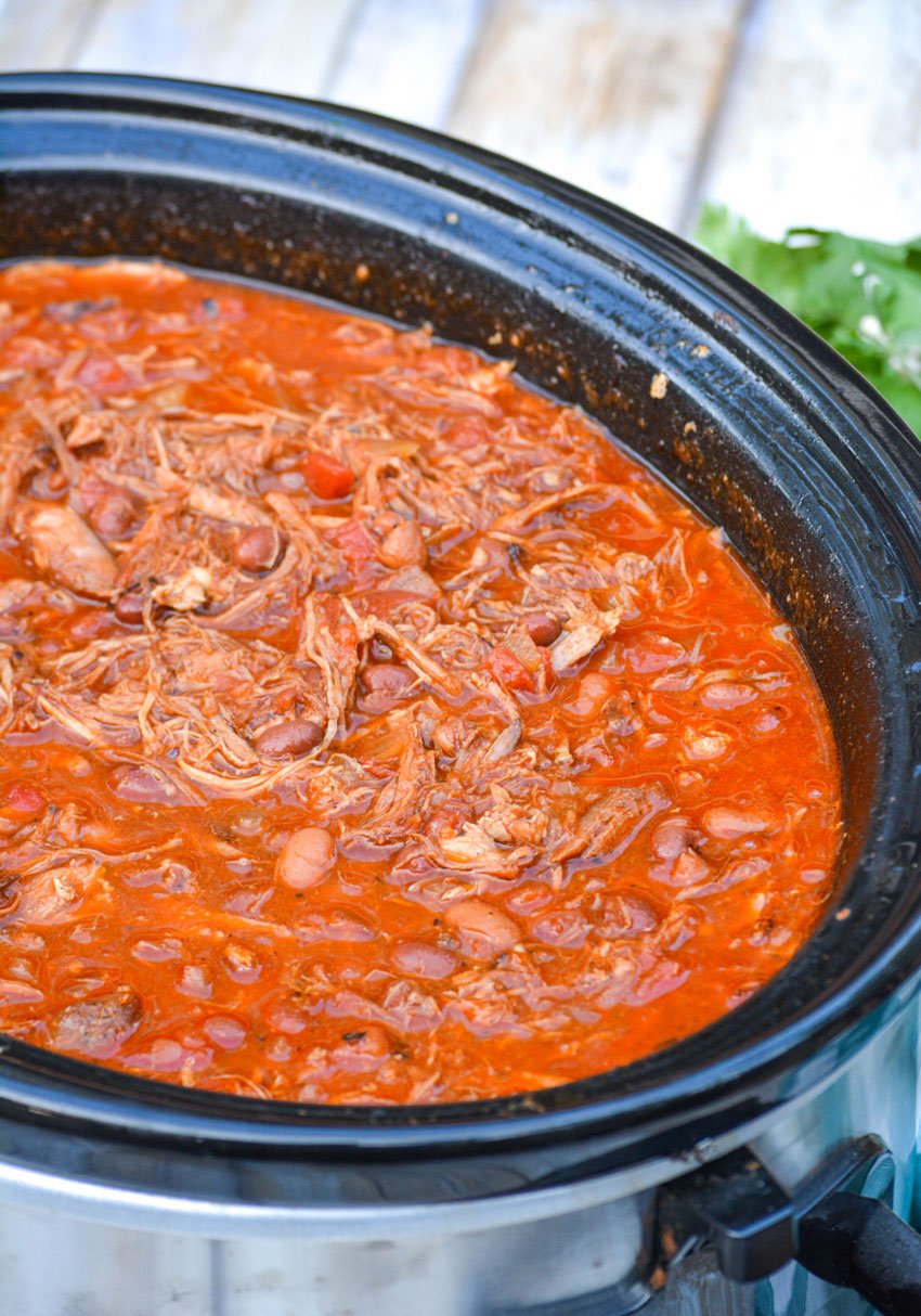 pulled pork chili in the bowl of a black crockpot