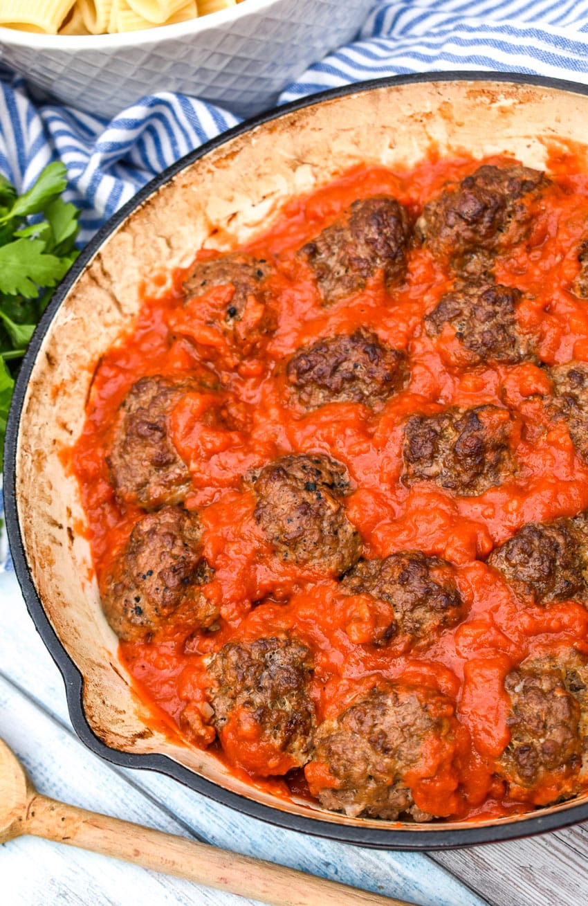 smoked meatballs in red sauce in a cast iron skillet