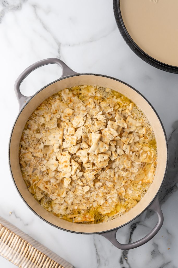 chicken mull with crushed saltine crackers in a large gray pot