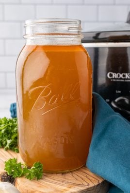 crockpot chicken broth in a tall glass mason jar