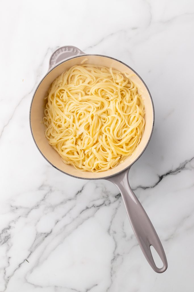 cooked pasta in a gray skillet