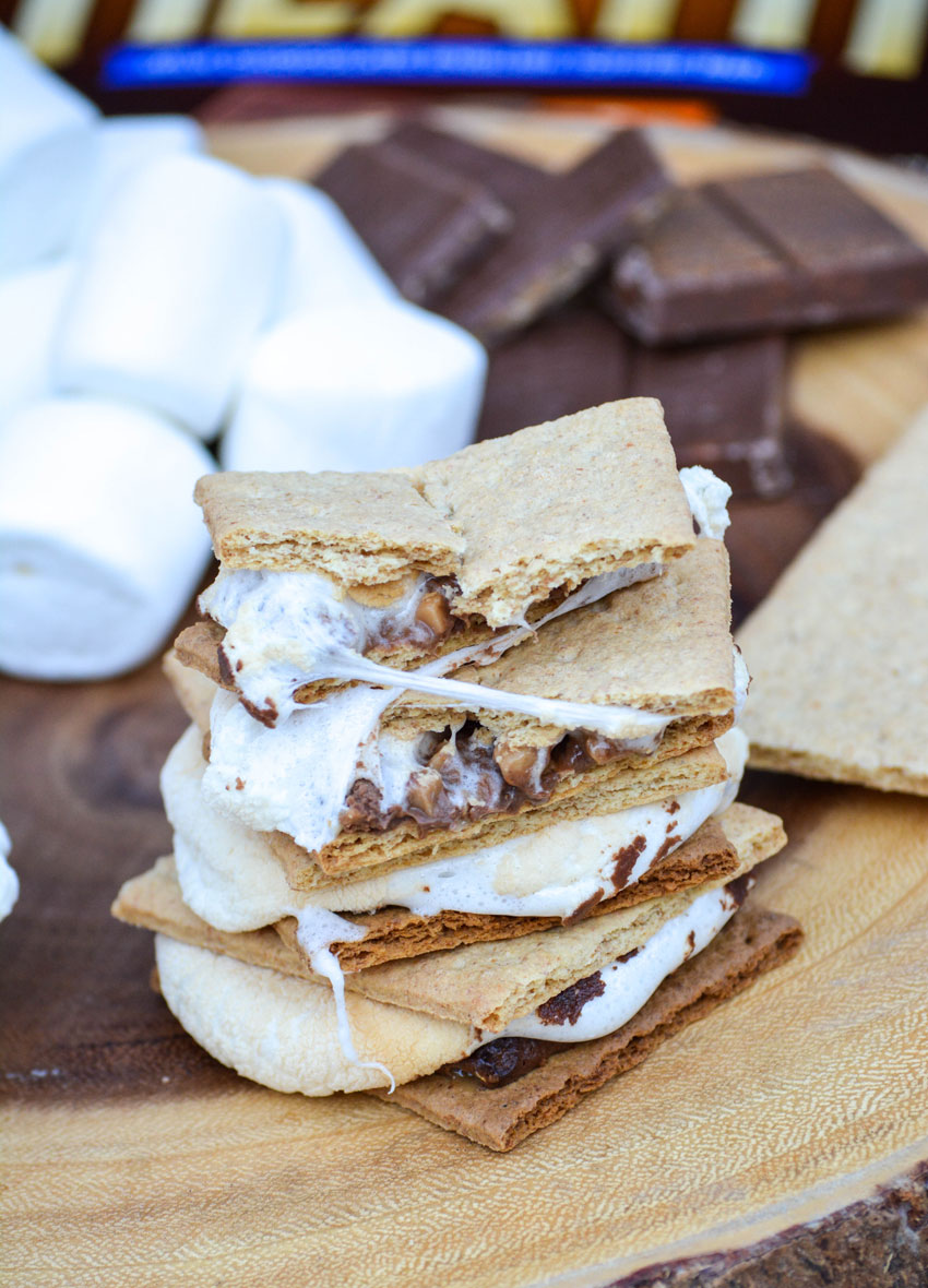easy air fryer s'mores stacked together on a wooden cutting board