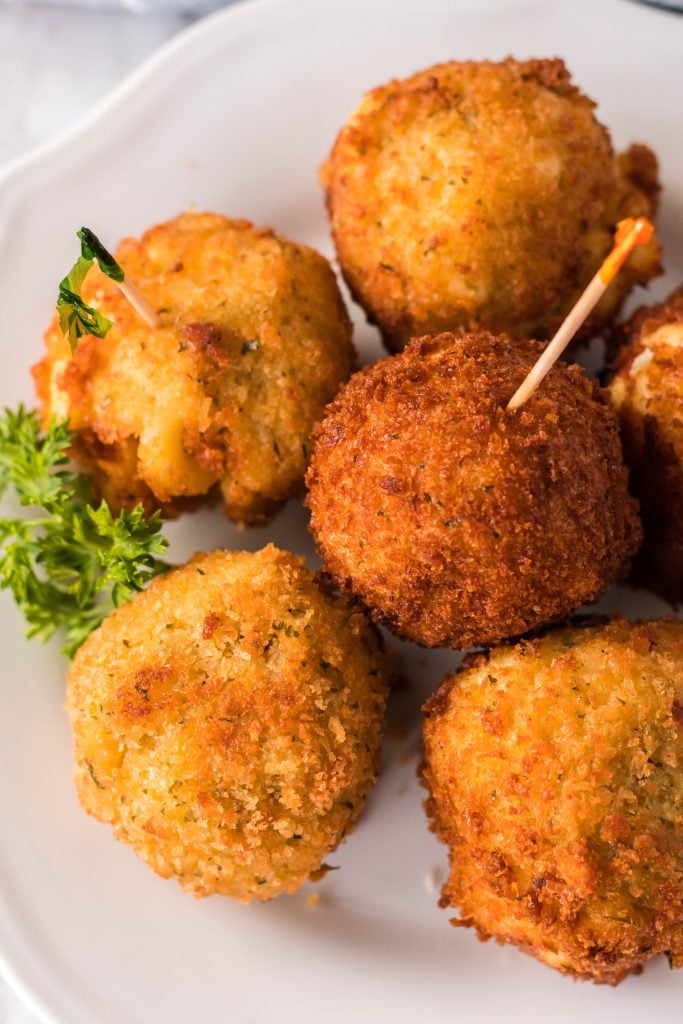copycat cheesecake factory fried mac and cheese balls on a white plate