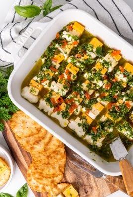 marinated cheese appetizer in a white casserole dish