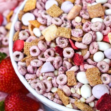 the viral strawberry snack mix from tiktok shown in a white bowl with fresh strawberries on the side
