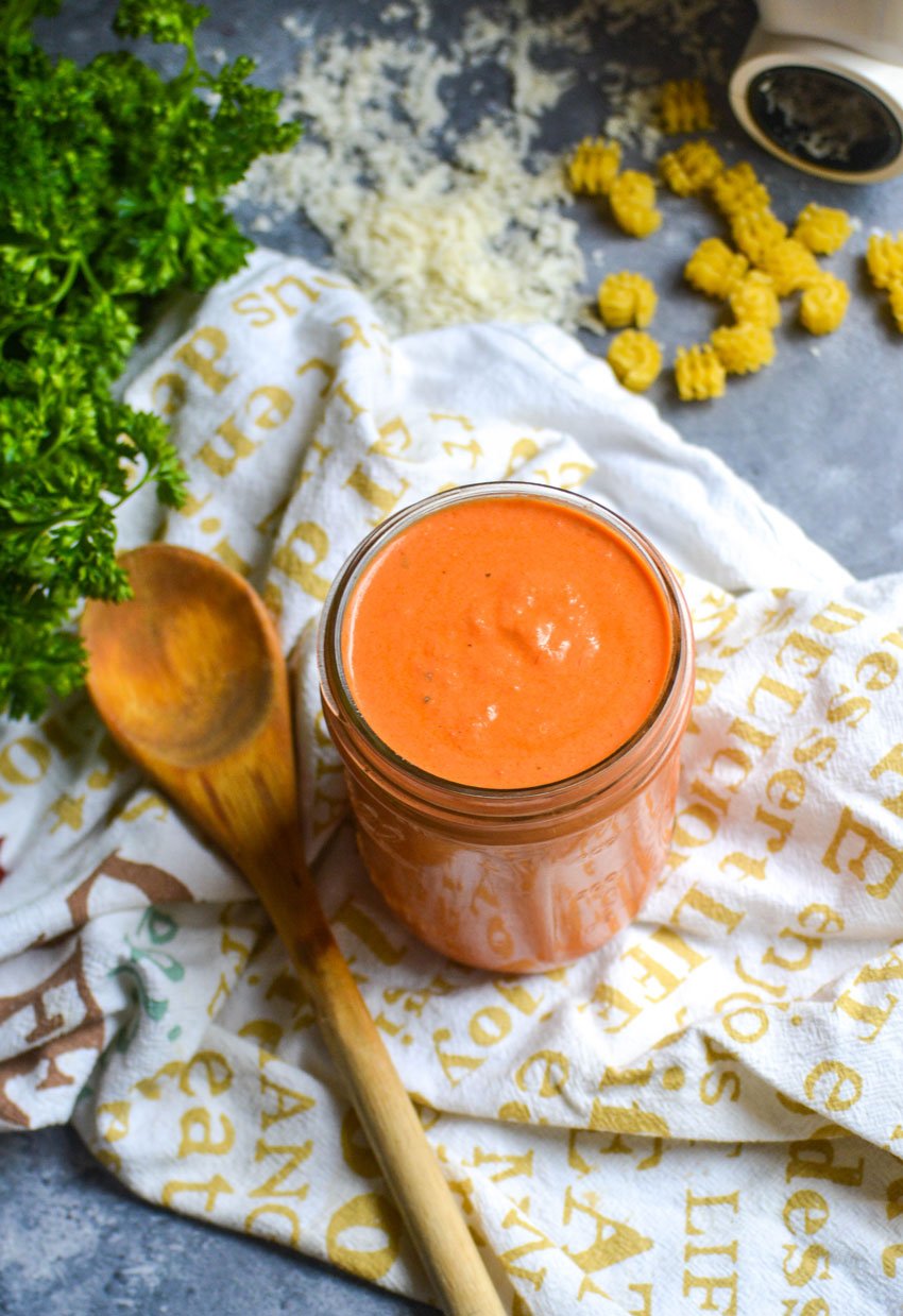 quick and easy vodka sauce in a mason jar next to a wooden spoon
