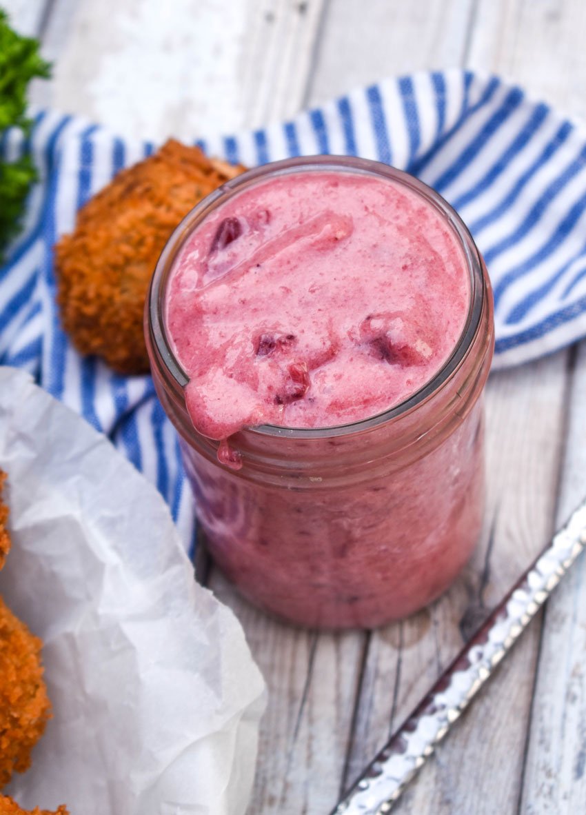 creamy cranberry dipping sauce in a small glass mason jar