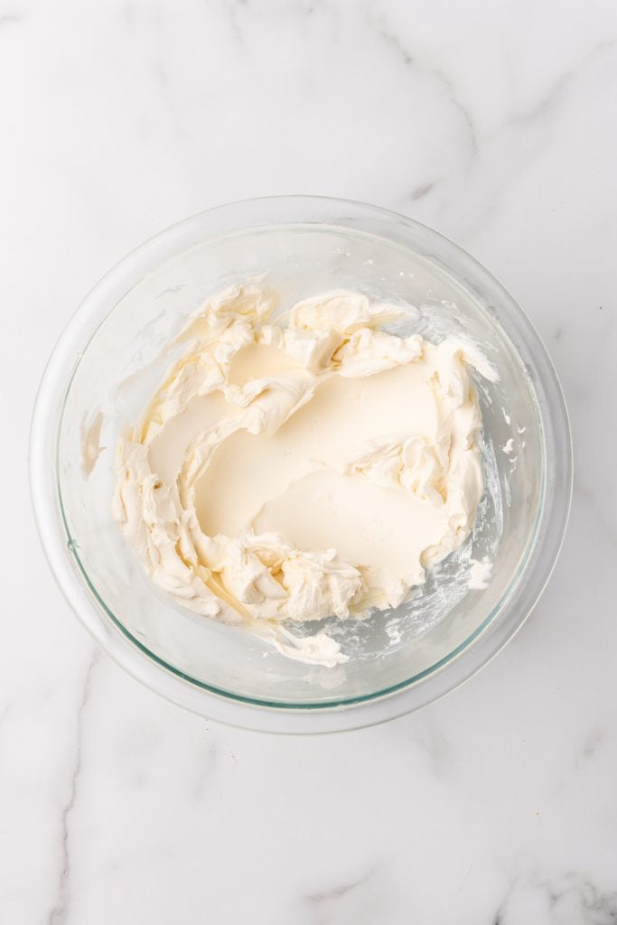 whipped cream cheese in a glass mixing bowl