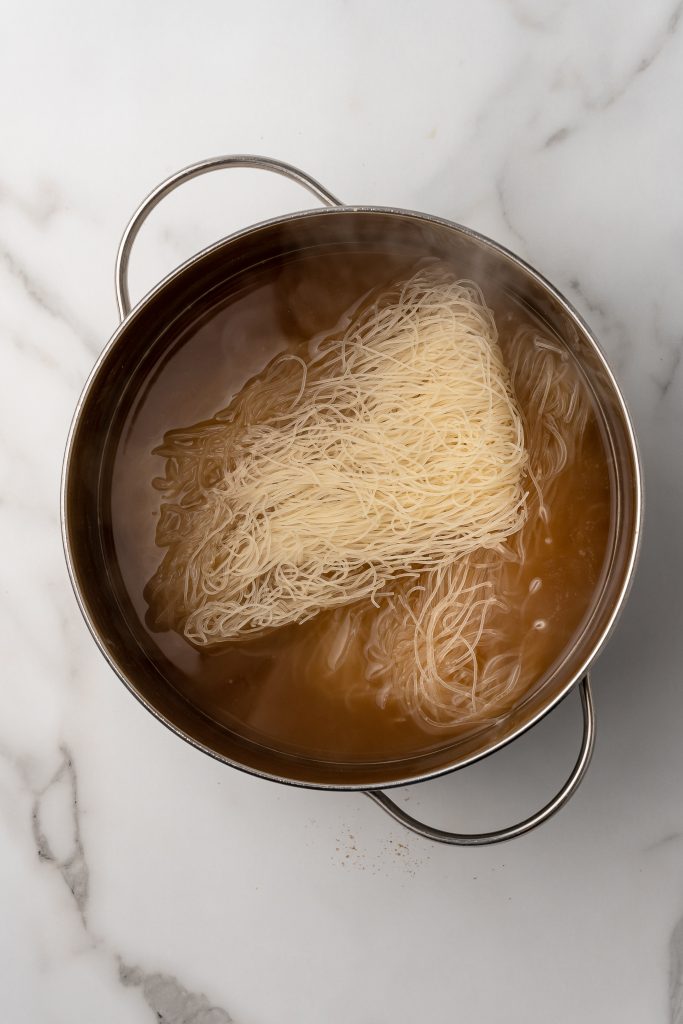rice noodles in a large silver pot of water