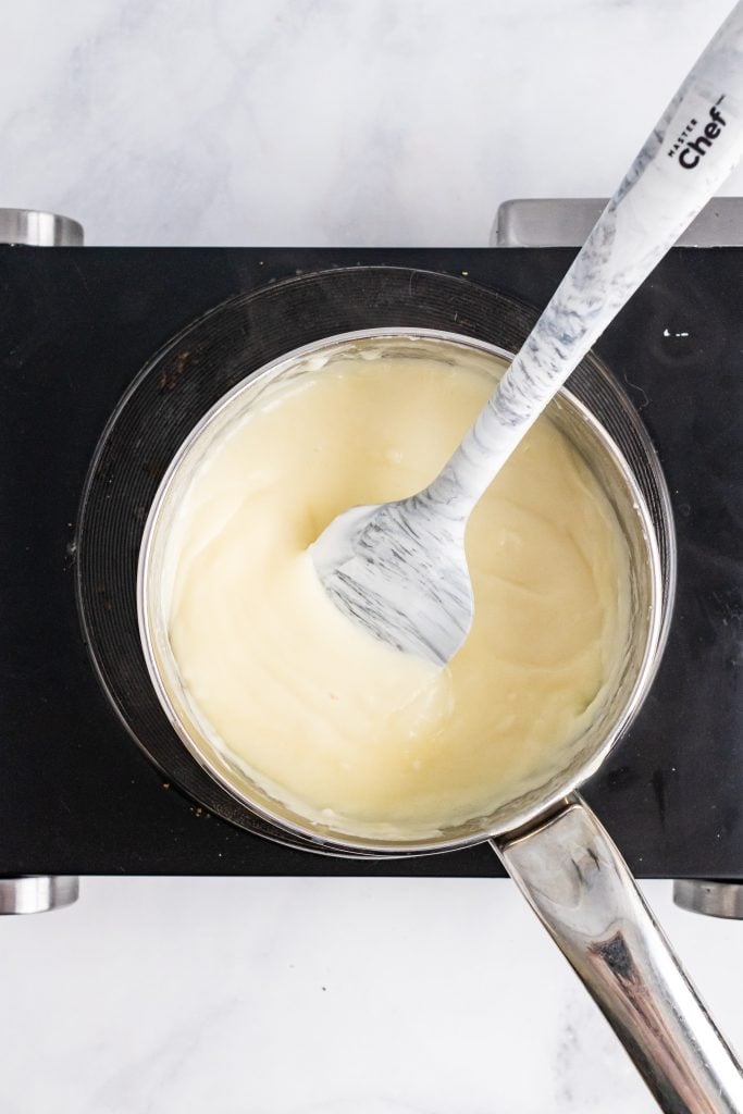 a smooth cream sauce in a small metal pot