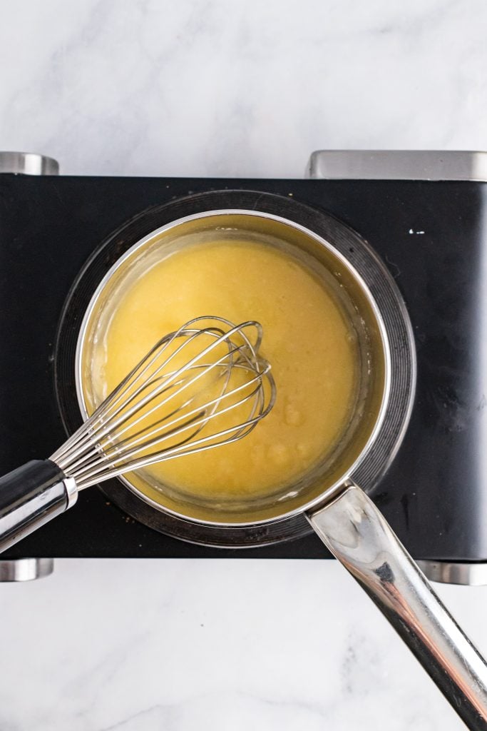 a whisk in a pot with a butter and flour roux