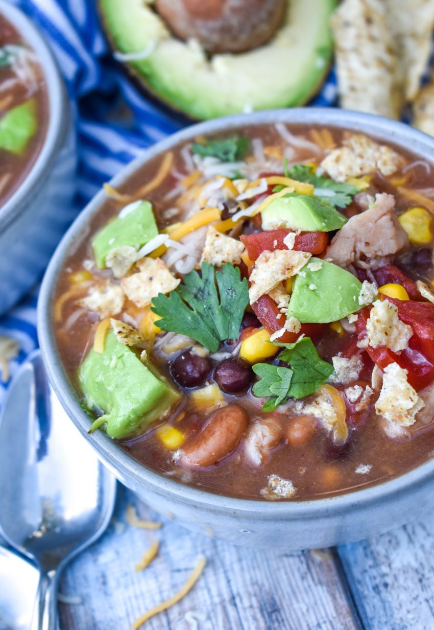 easy can chicken taco soup in two gray bowls