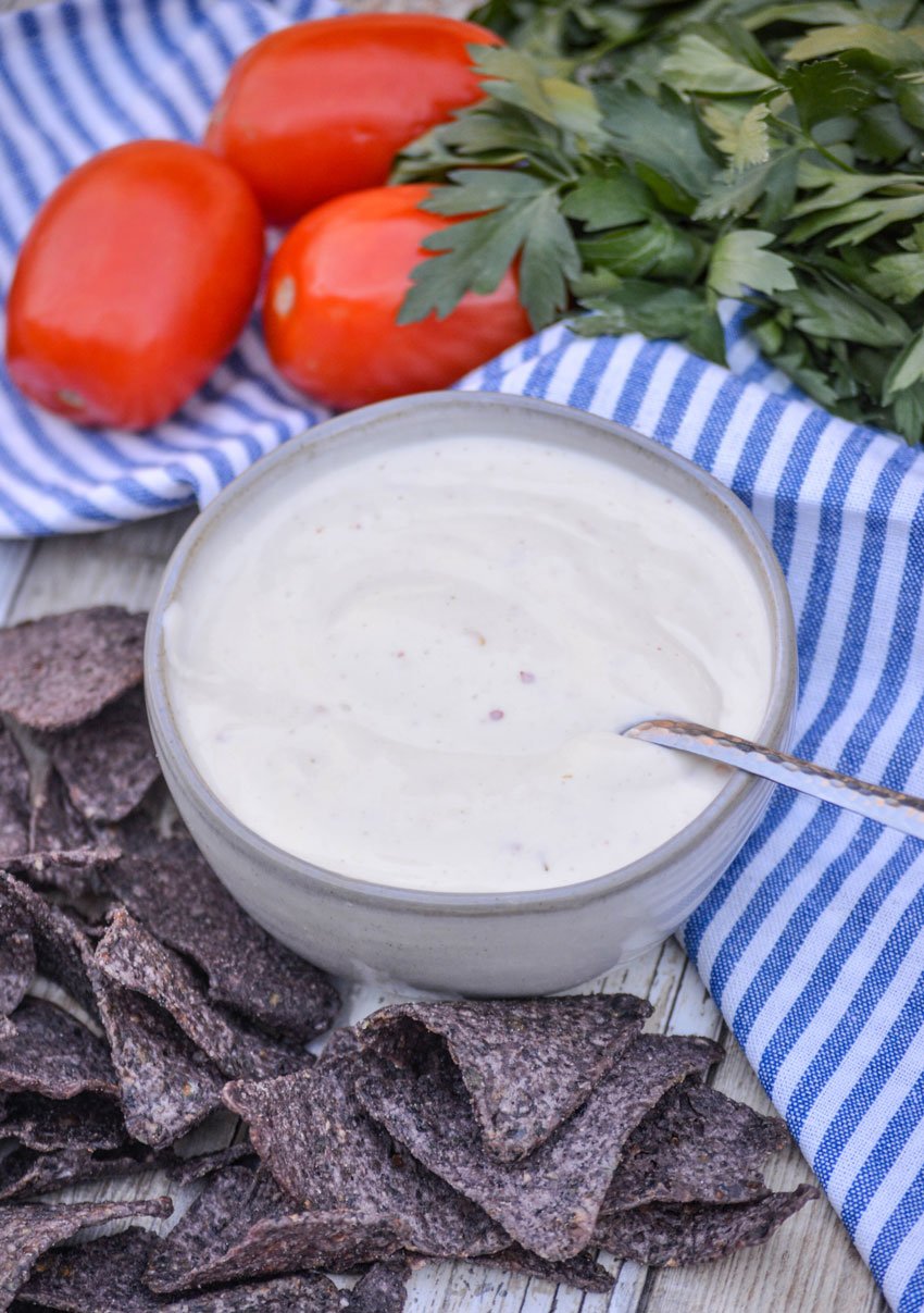 a silver spoon in a small bowl of Mexican white ranch sauce