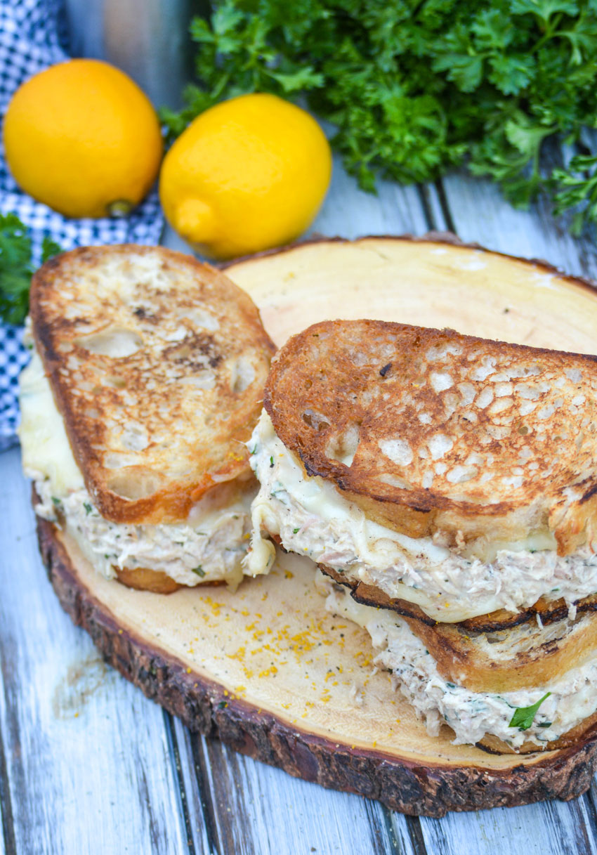 cheesy tuna melt sandwiches on a wooden cutting board