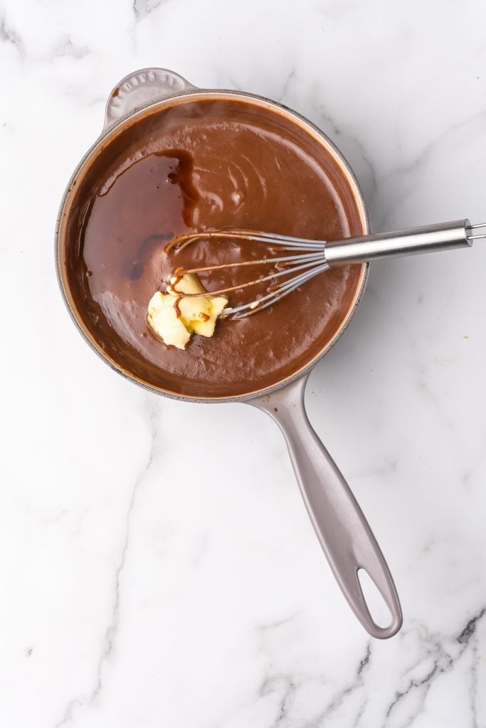 chocolate gravy being made in a gray sauce pan