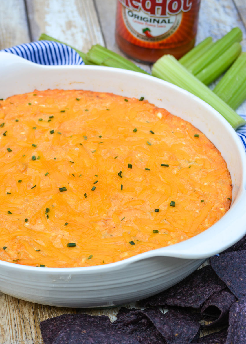 the best buffalo chicken dip in a white serving bowl