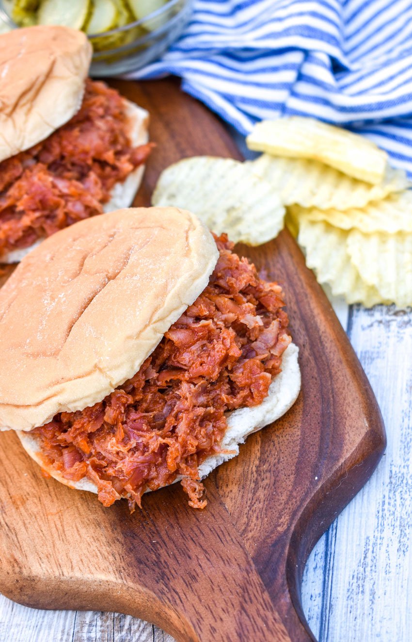 Pittsburgh Chipped Ham Barbecue on a fluffy hamburger bun on a wooden cutting board
