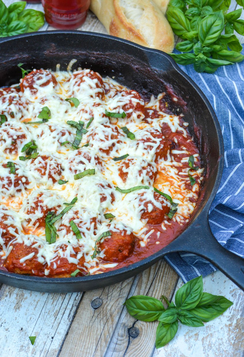 a meatball parmesan skillet in a black cast iron skillet